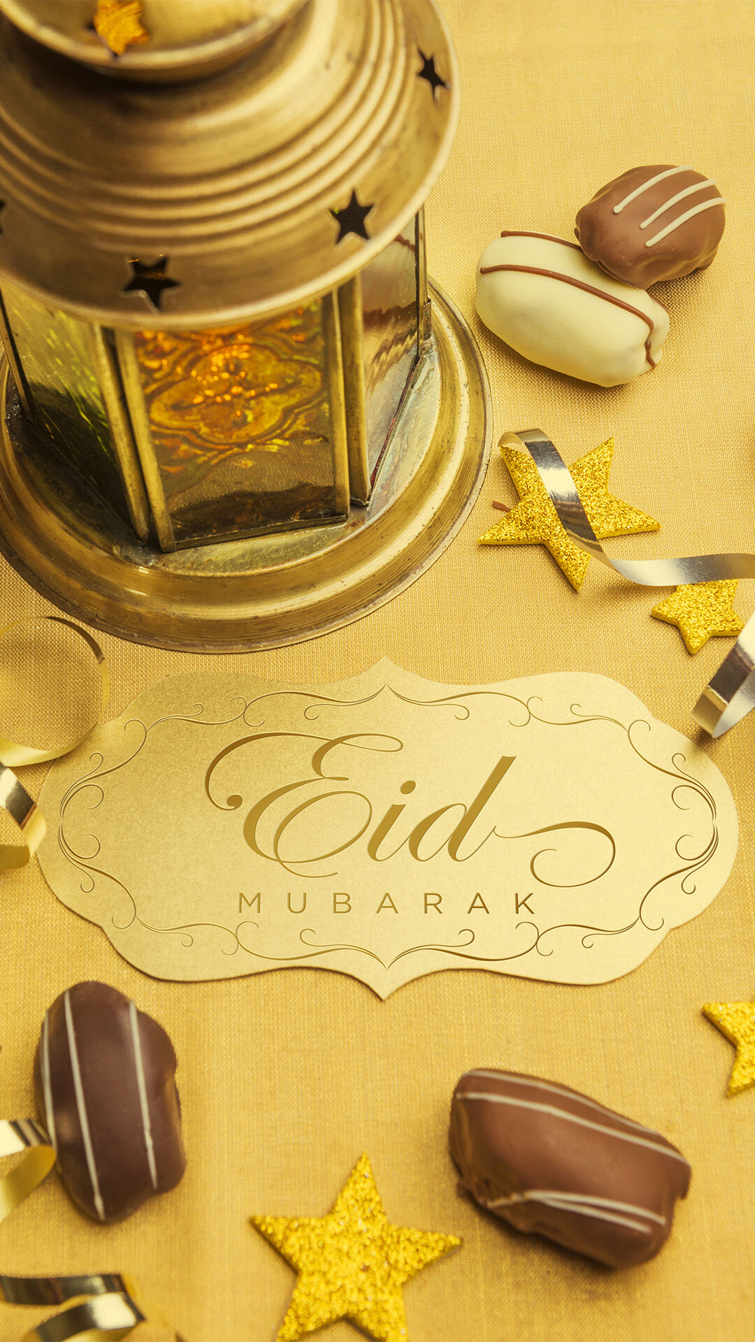 Golden Eid Mubarak card with decorative lantern, chocolates, and festive ornaments